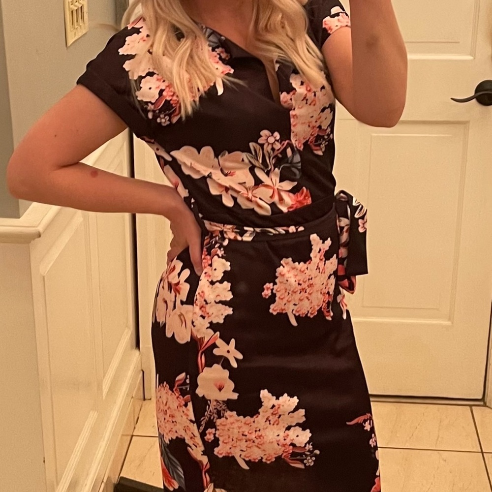 Navy blue almost black dress with pink floral design with belt